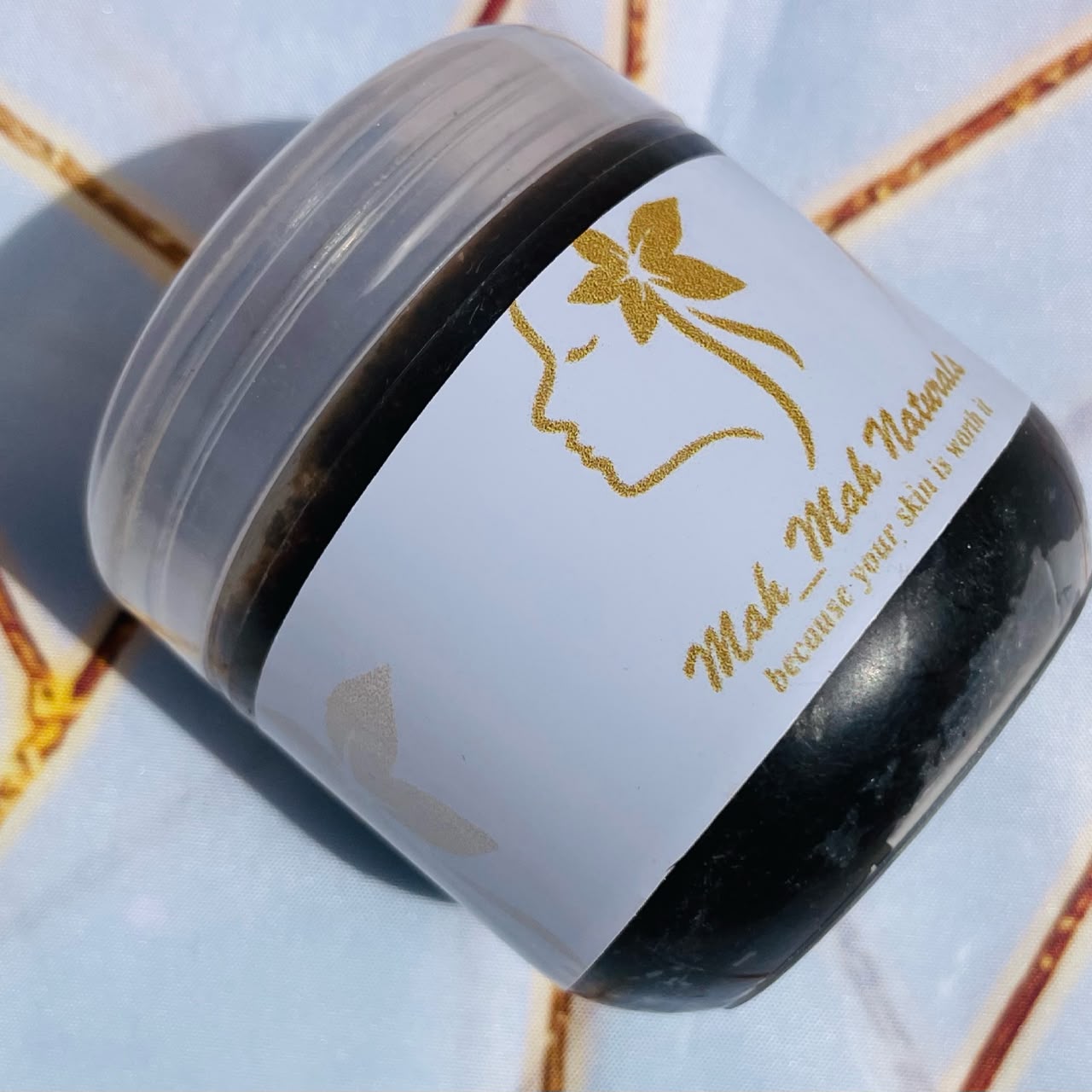 Jar of MahMah Naturals homemade black soap